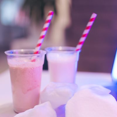 two cups of milkshakes with straws
